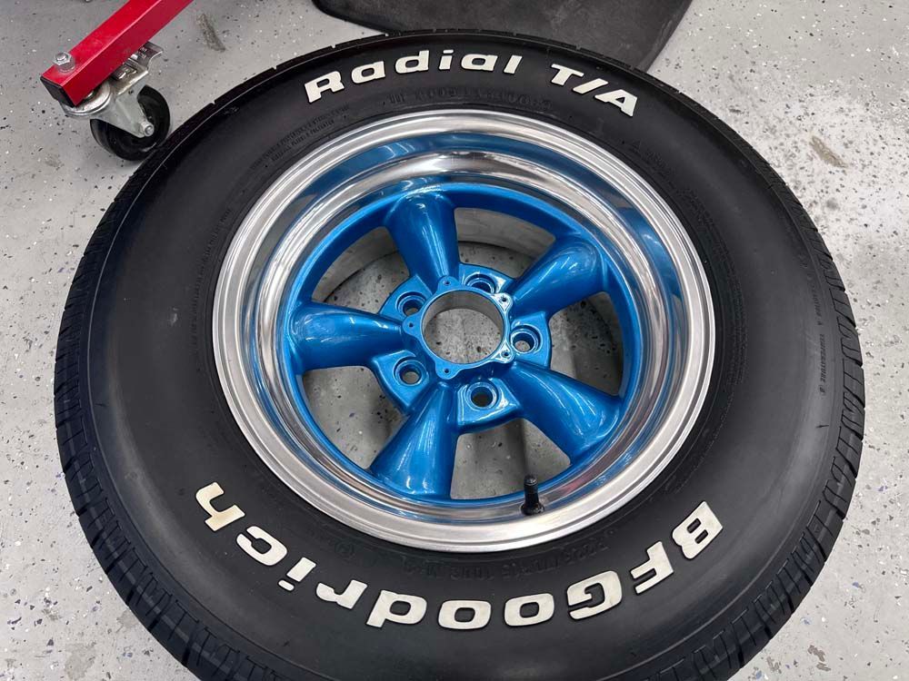 A bfgoodrich tire with a blue rim