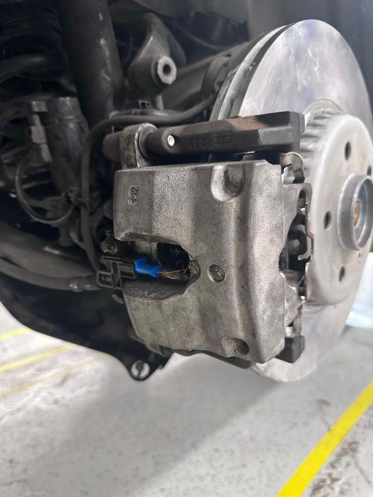 A close up of a brake caliper on a car.