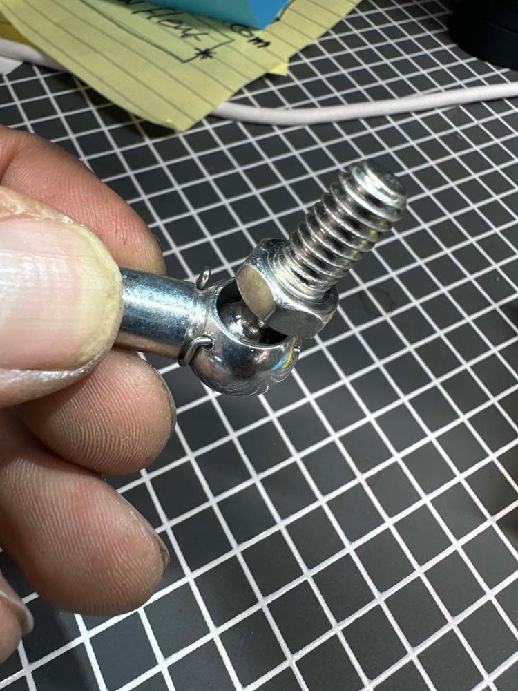 A person is holding a metal object in their hand