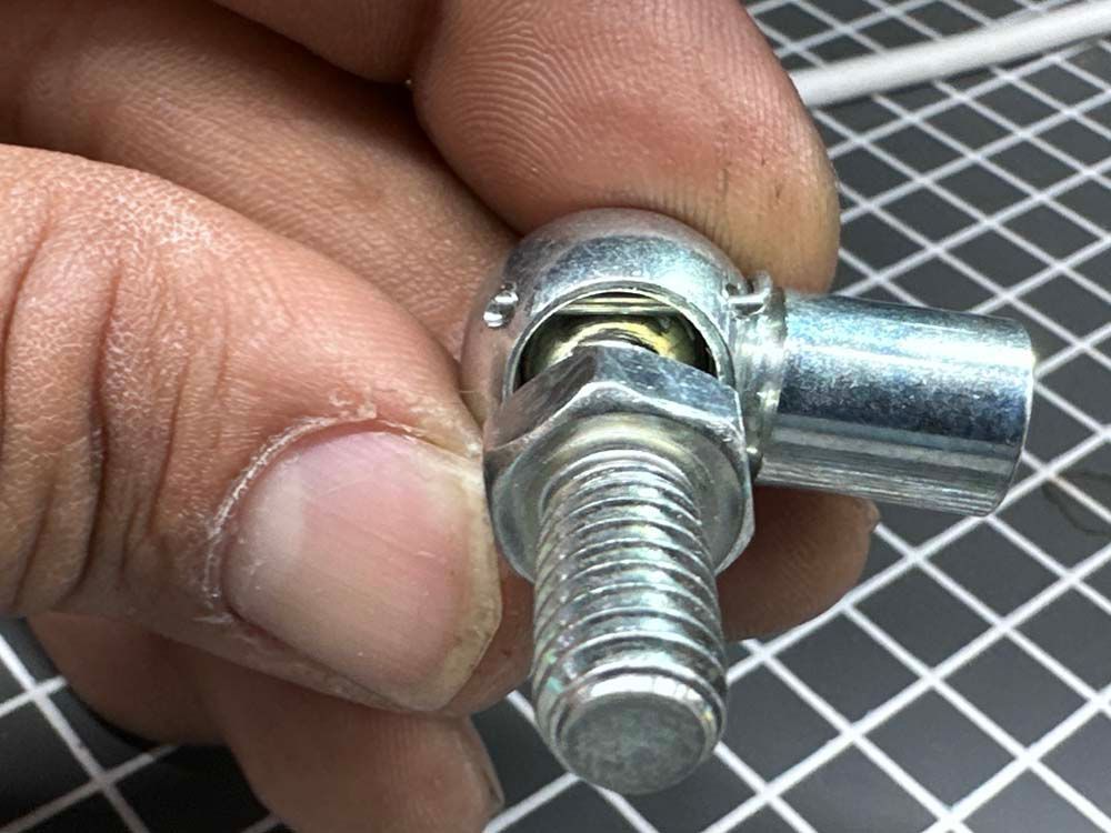A close up of a person holding a metal object in their hand.
