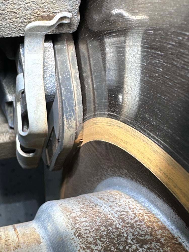 A close up of a brake pad on a car.
