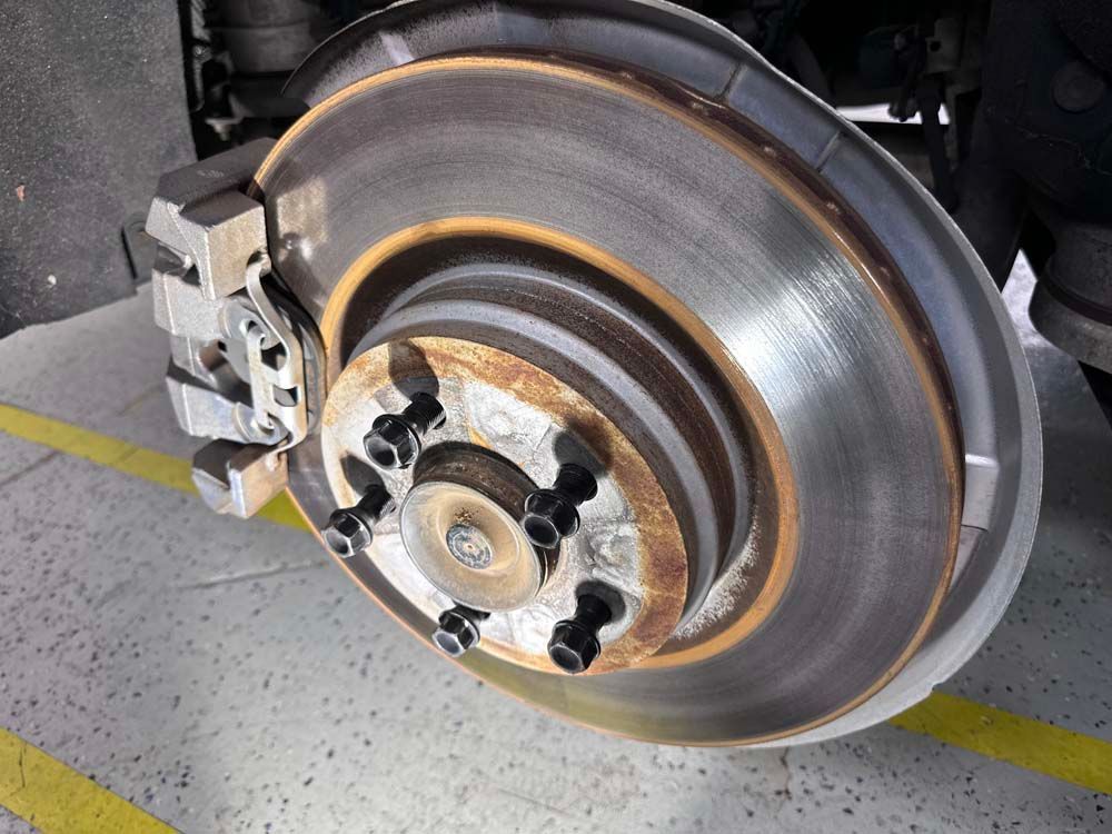 A close up of a brake disc on a car
