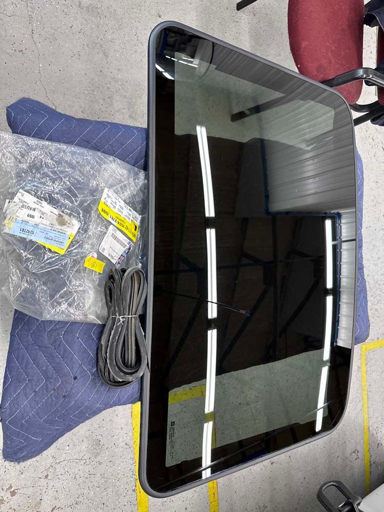 A sunroof is sitting on top of a blue blanket on a table.