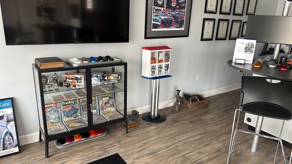 A living room with a display case filled with toys and a television.