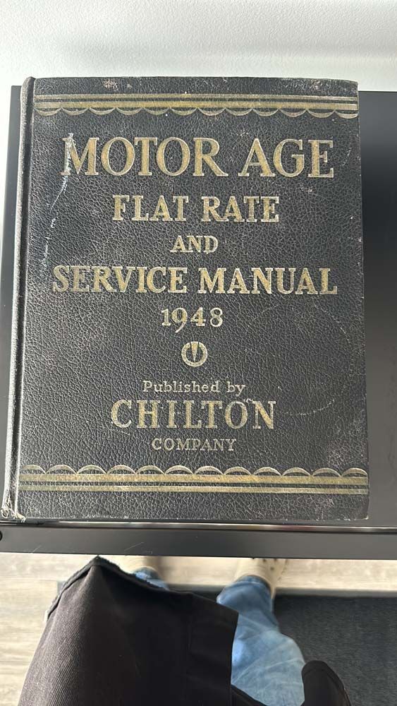 A black book titled motor age flat rate and service manual