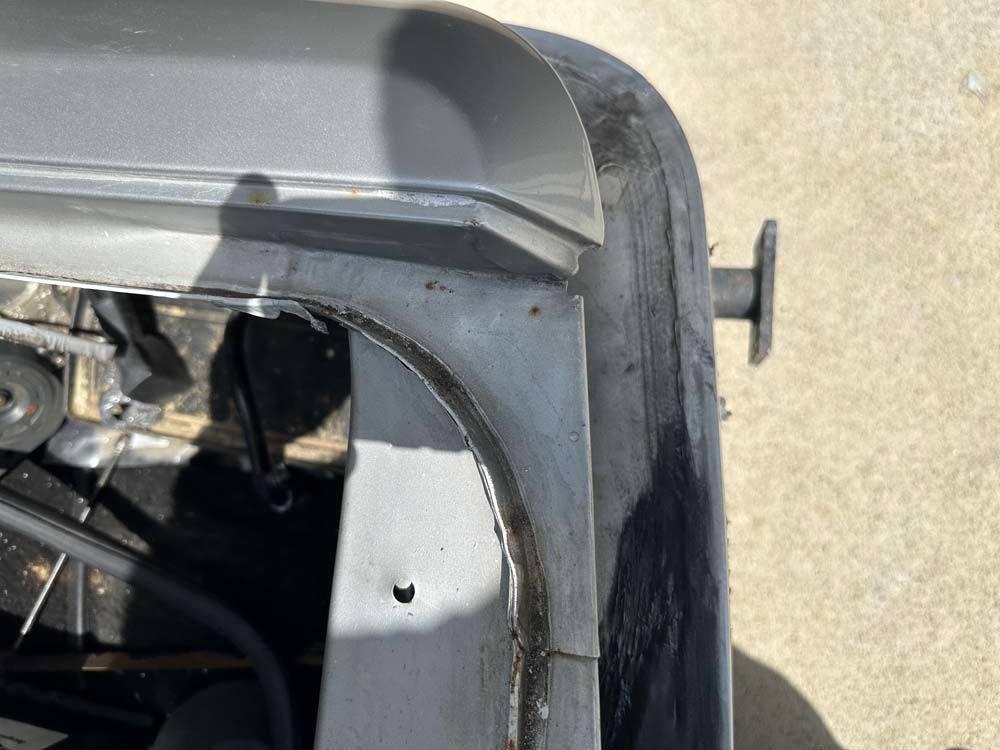 A close up of a car hood on a concrete surface.