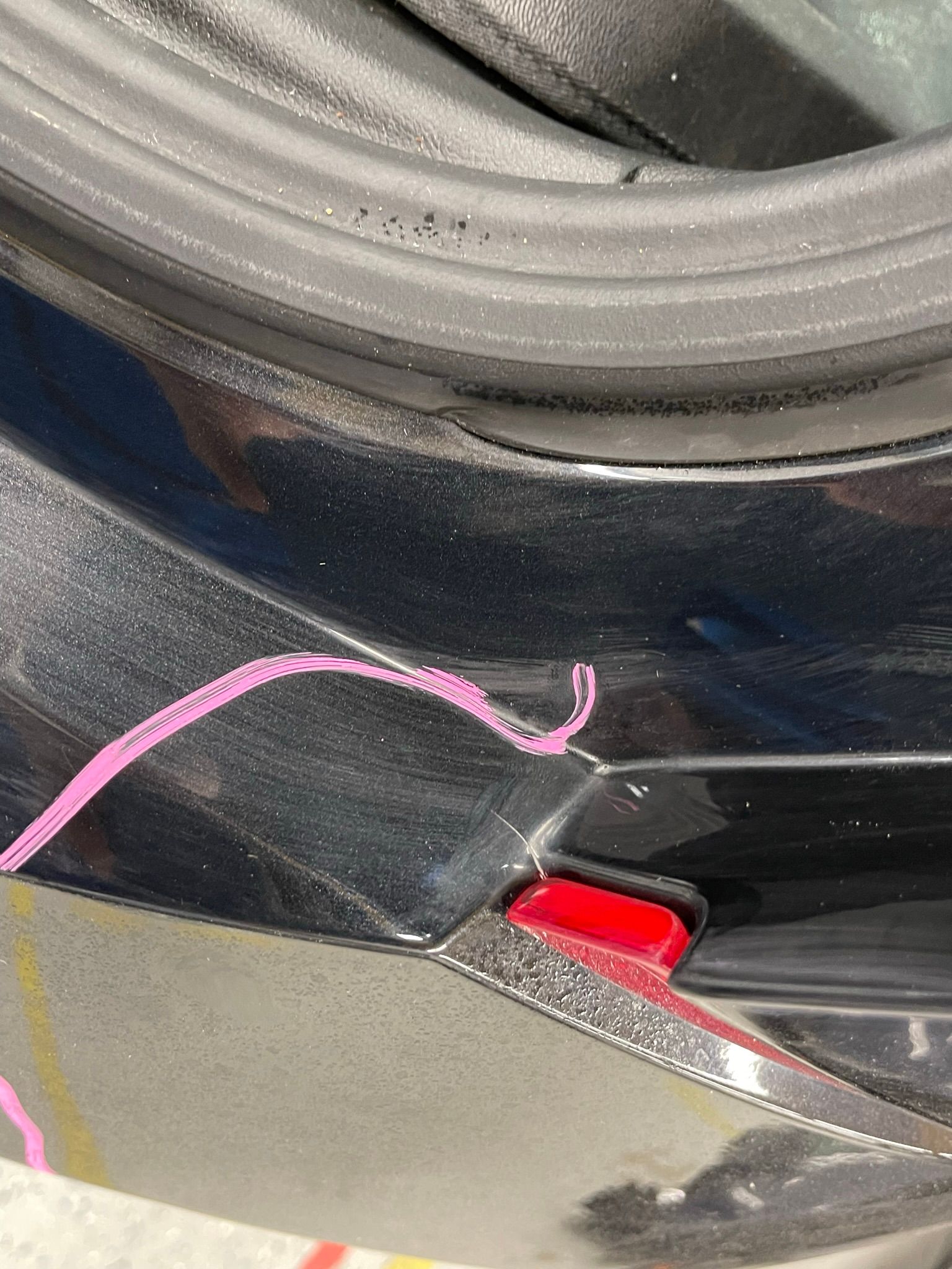 A close up of a black car with a red light on it.