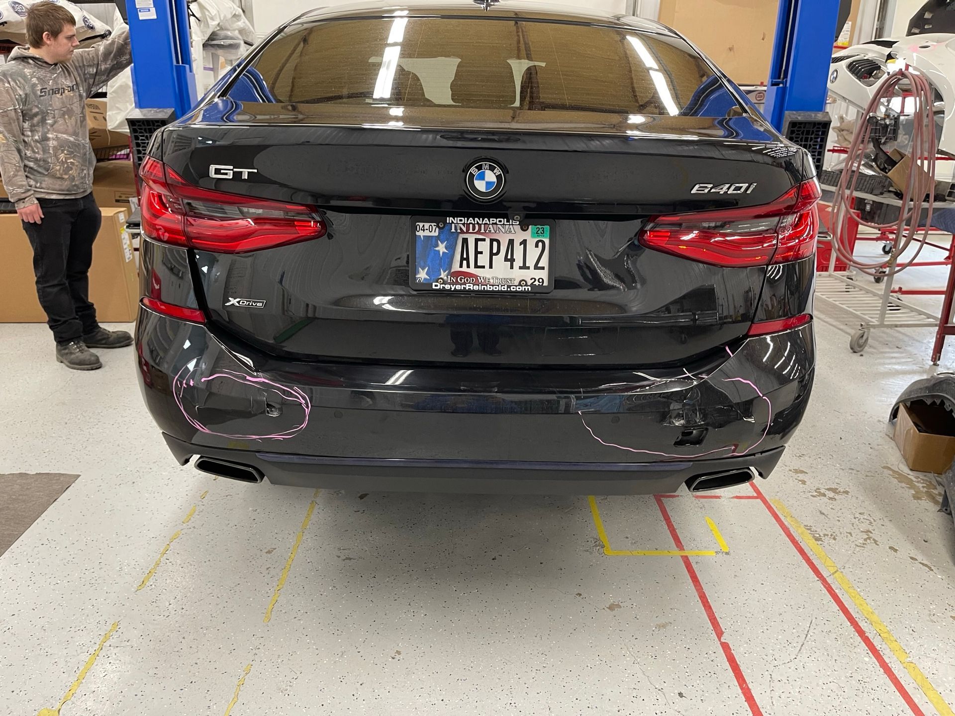 A black bmw with a license plate that says aep412