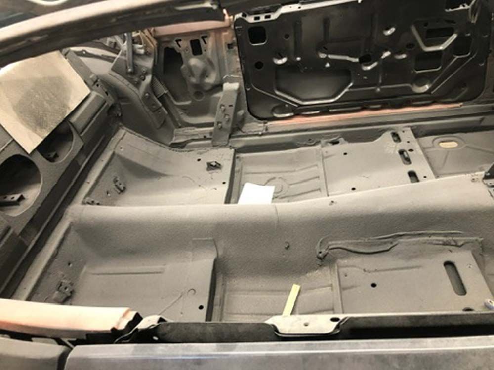 The inside of a car with the trunk open.