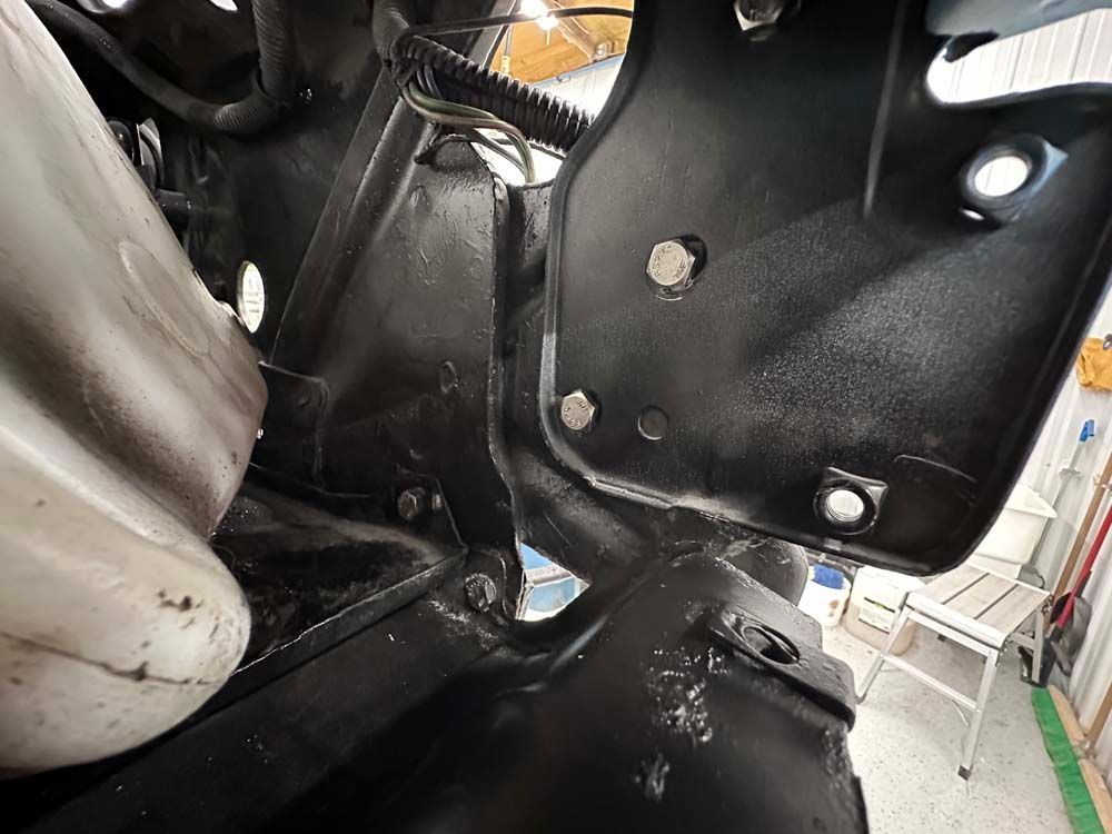 A close up of a motorcycle engine in a garage.