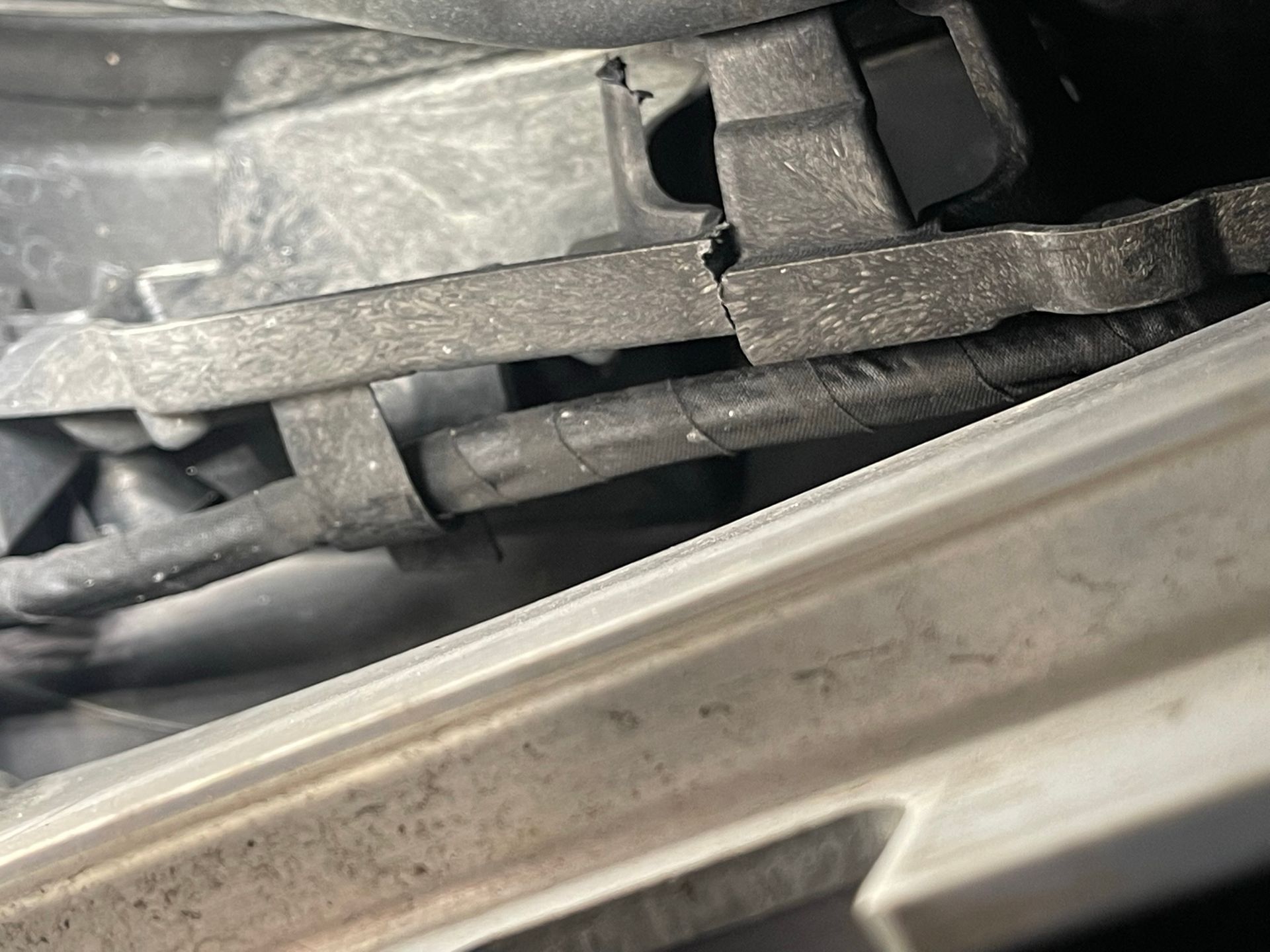 A close up of a metal object on the side of a car.