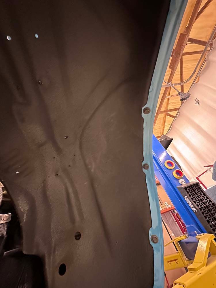 A car is being worked on in a garage.