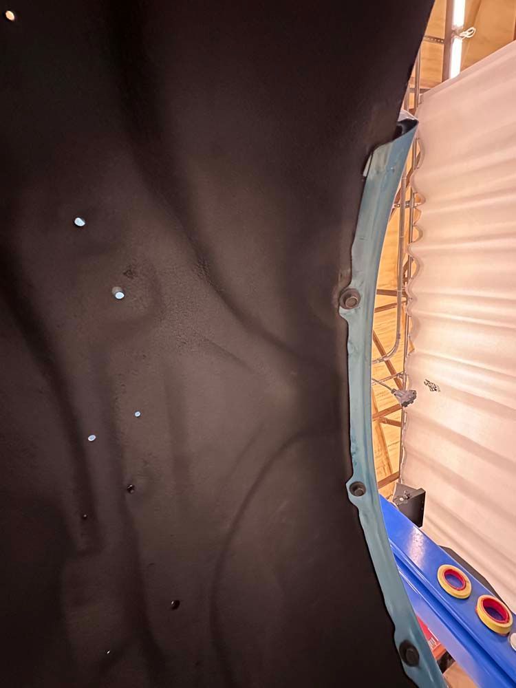 Dark wall with blue trim, lights and a yellow backdrop.