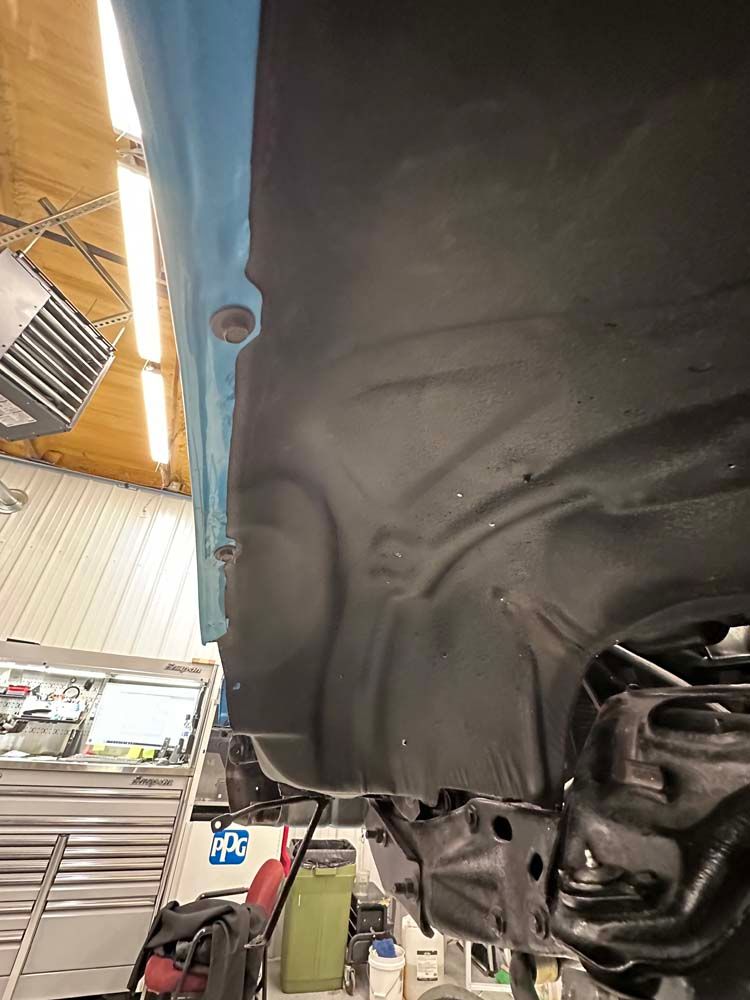 A car is being worked on in a garage.