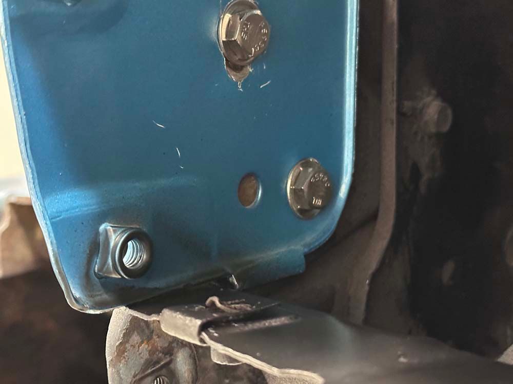 A close up of a blue object with screws on it