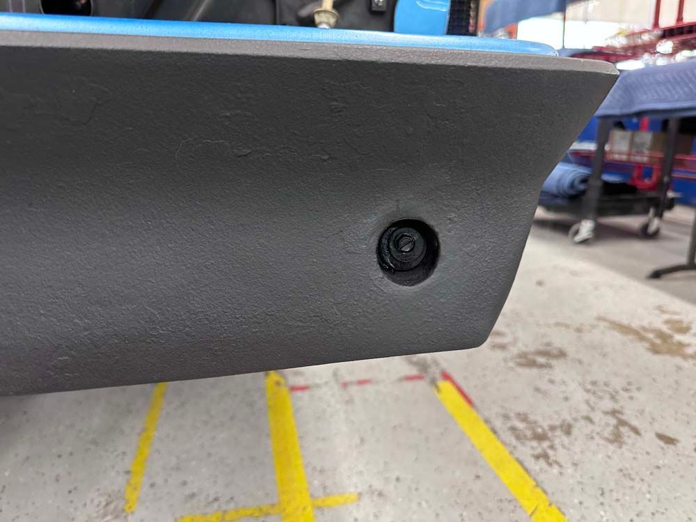 A close up of a car 's bumper in a parking lot.