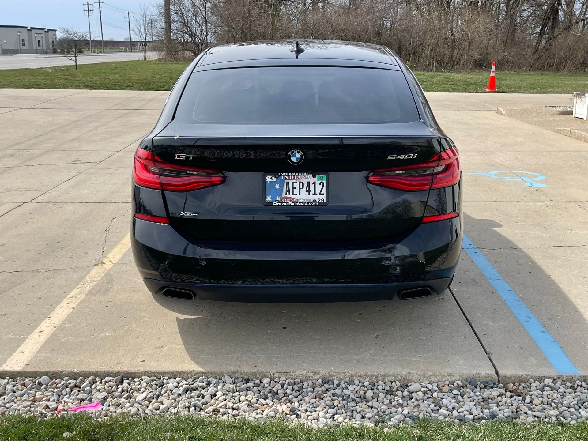 A black bmw is parked in a parking lot with a license plate that says illinois