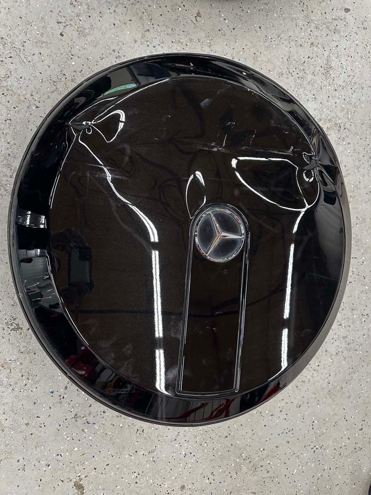 A black tire cover with a mercedes logo on it