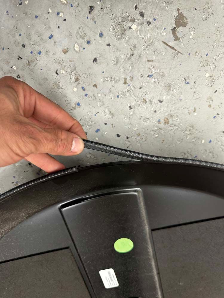 A person is holding a piece of plastic in their hand.