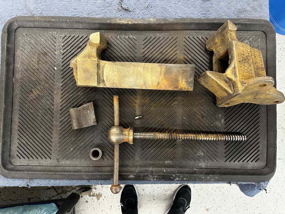 A vise is sitting on top of a tray on a table.