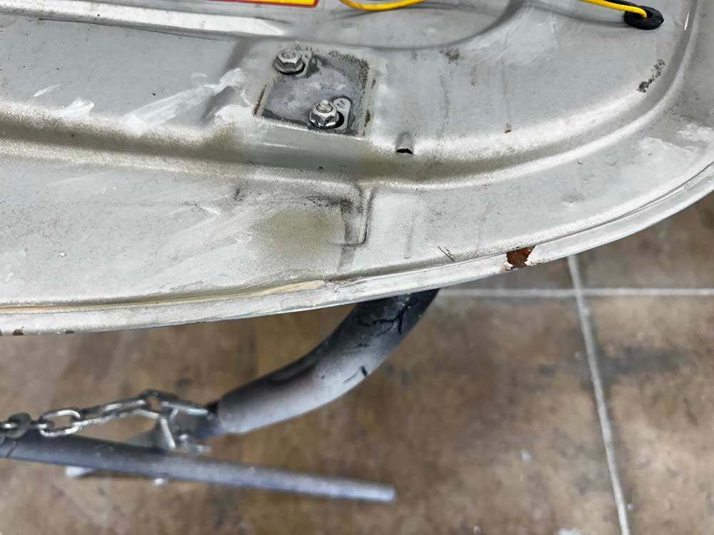 A close up of a metal object with a chain attached to it.