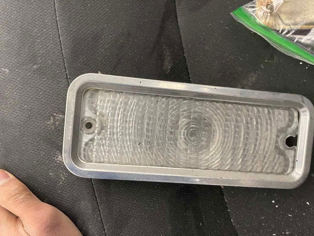 A person is holding a light that is sitting on a table.