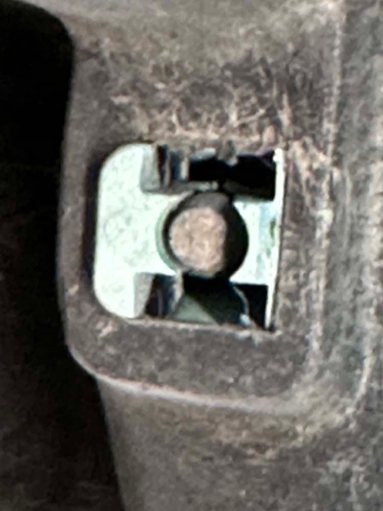 A close up of a metal object with a hole in it.