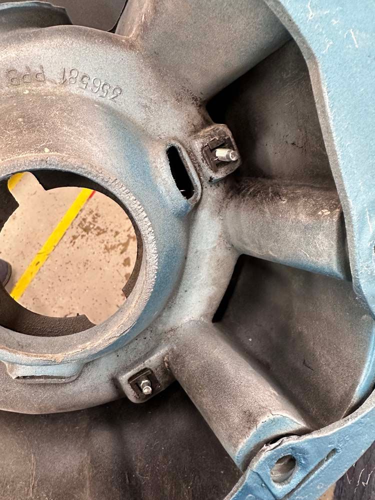 A close up of a metal object with a hole in the middle.