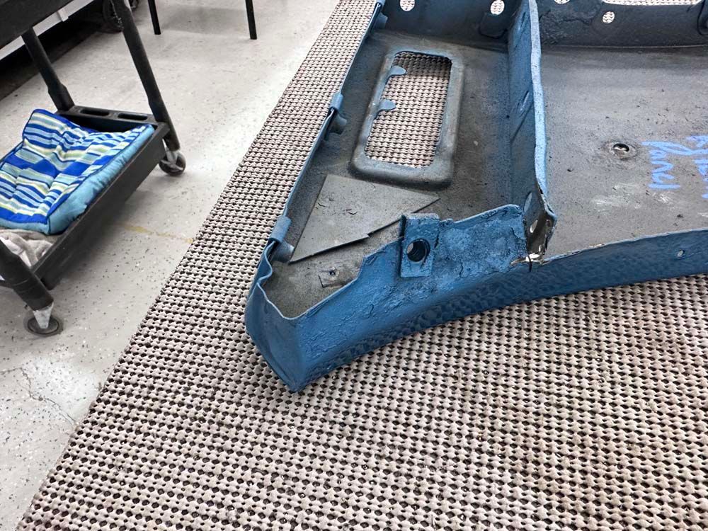 A piece of blue plastic is laying on a rug on the floor.