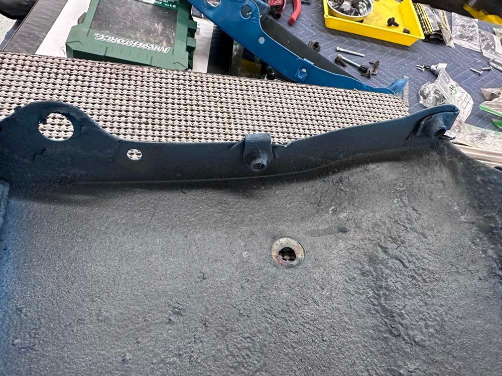 A piece of metal with a hole in it is sitting on a table.