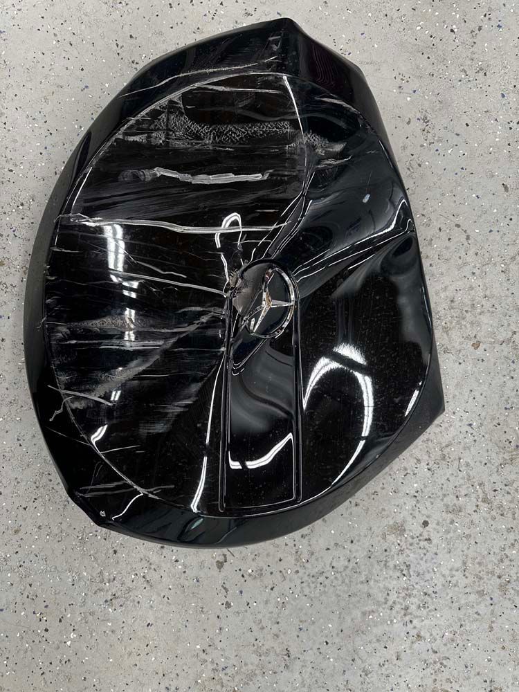 A black object is sitting on a concrete surface.