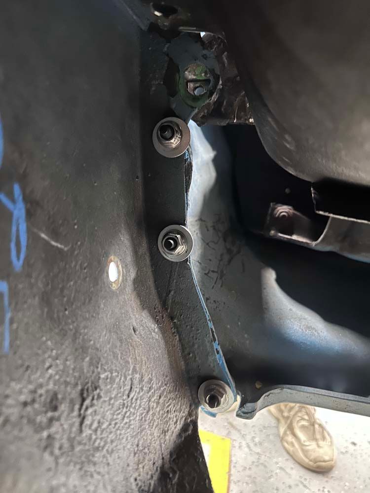 A close up of a piece of metal with screws on it.