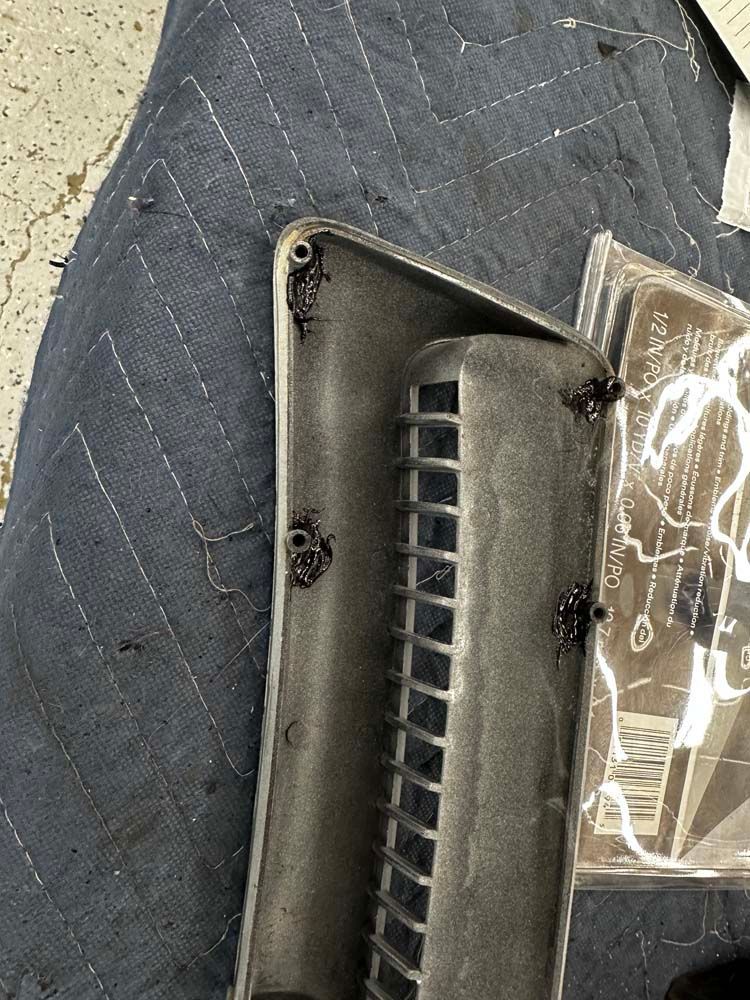 A piece of metal is sitting on top of a blue blanket.