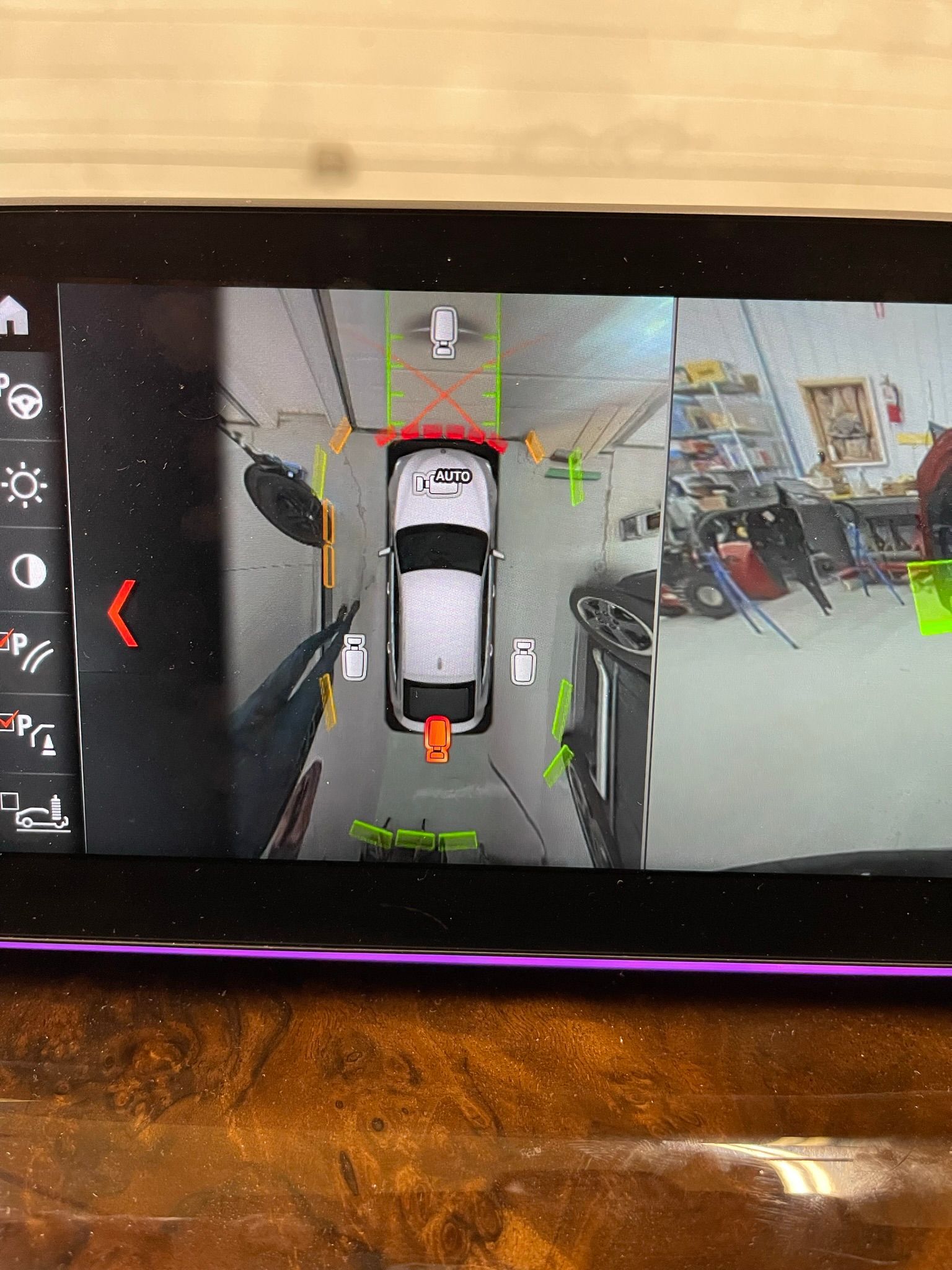 A car is parked in a parking lot on a tablet screen.