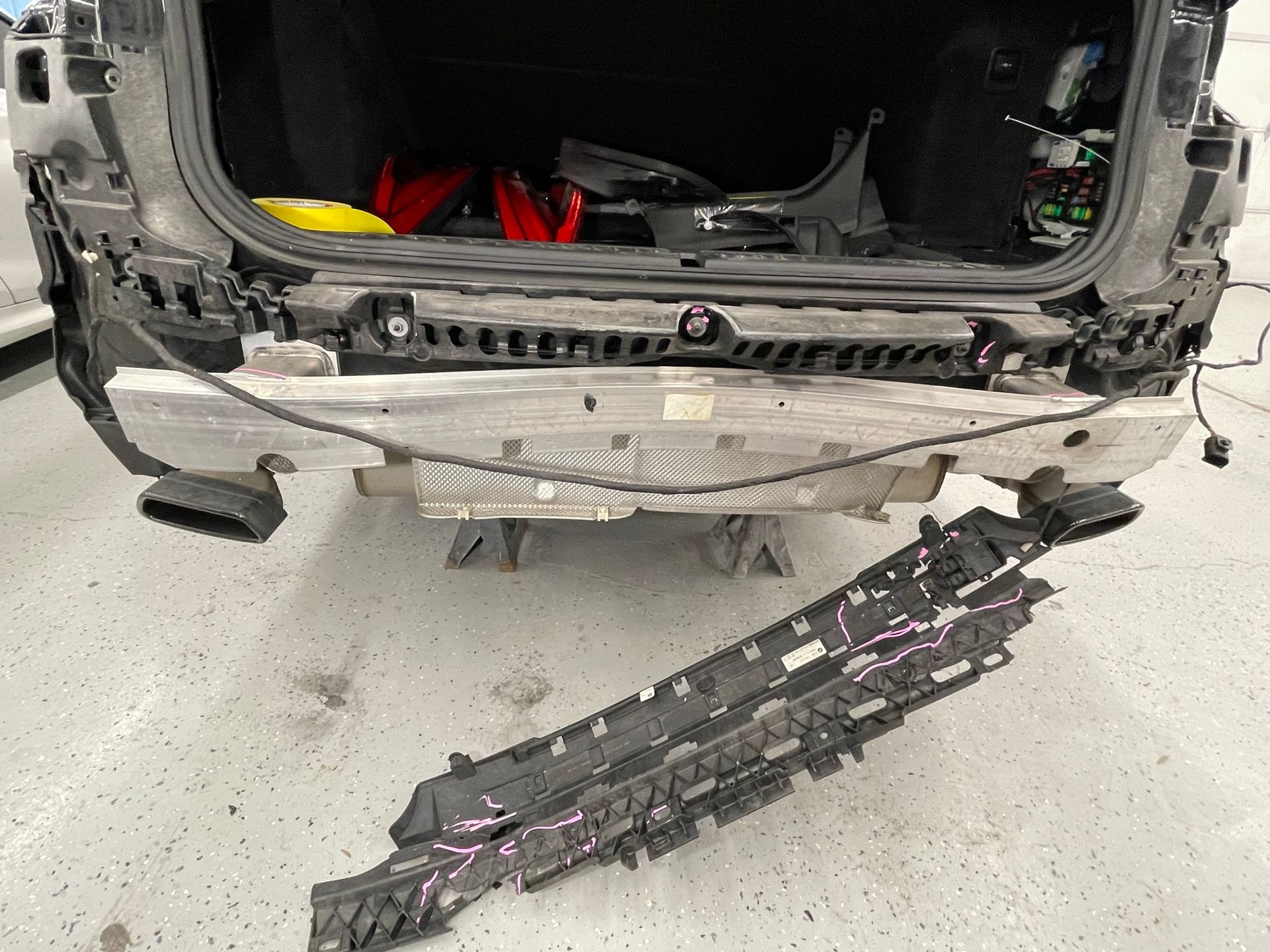 The rear bumper of a car is being removed.