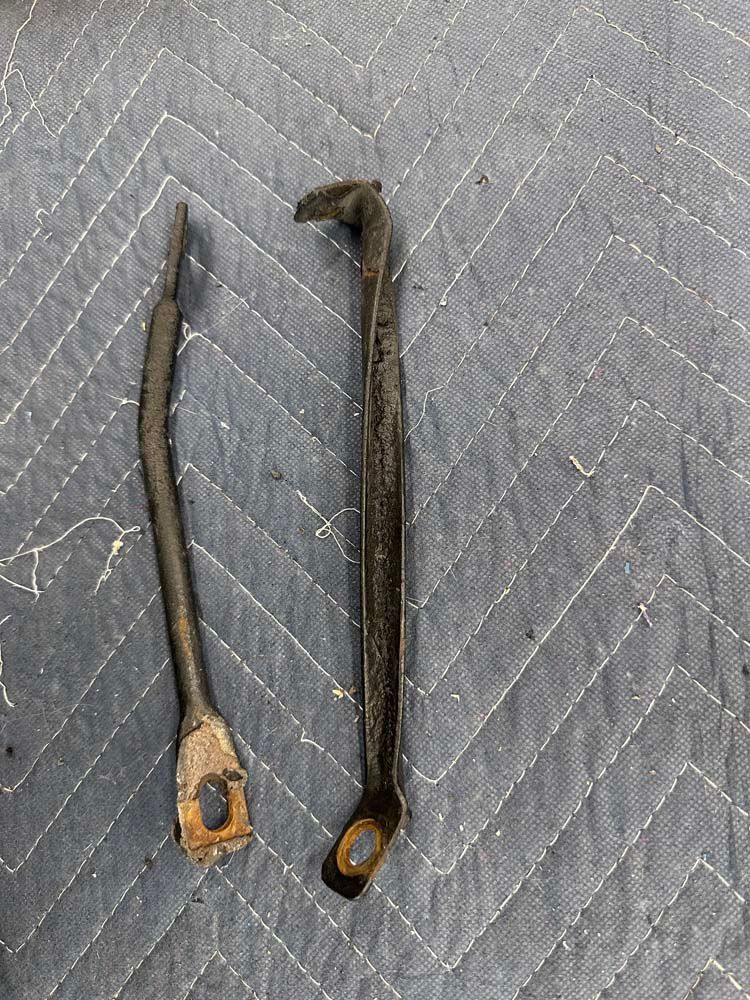 Two pieces of metal are sitting on top of a blue blanket.