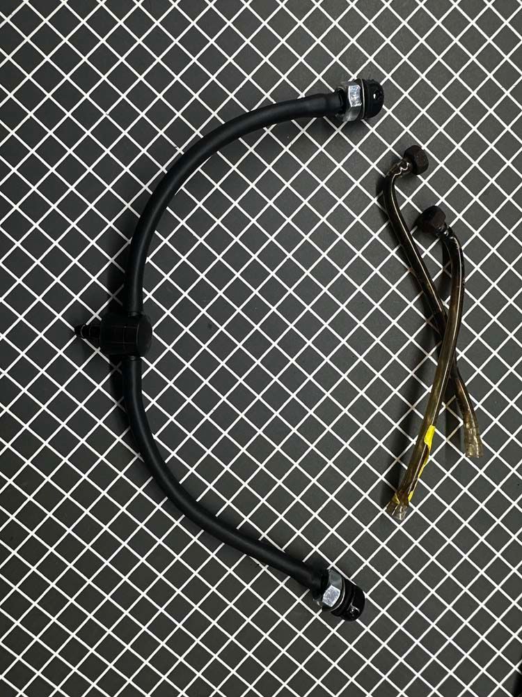 A black hose is sitting on top of a black and white checkered surface.