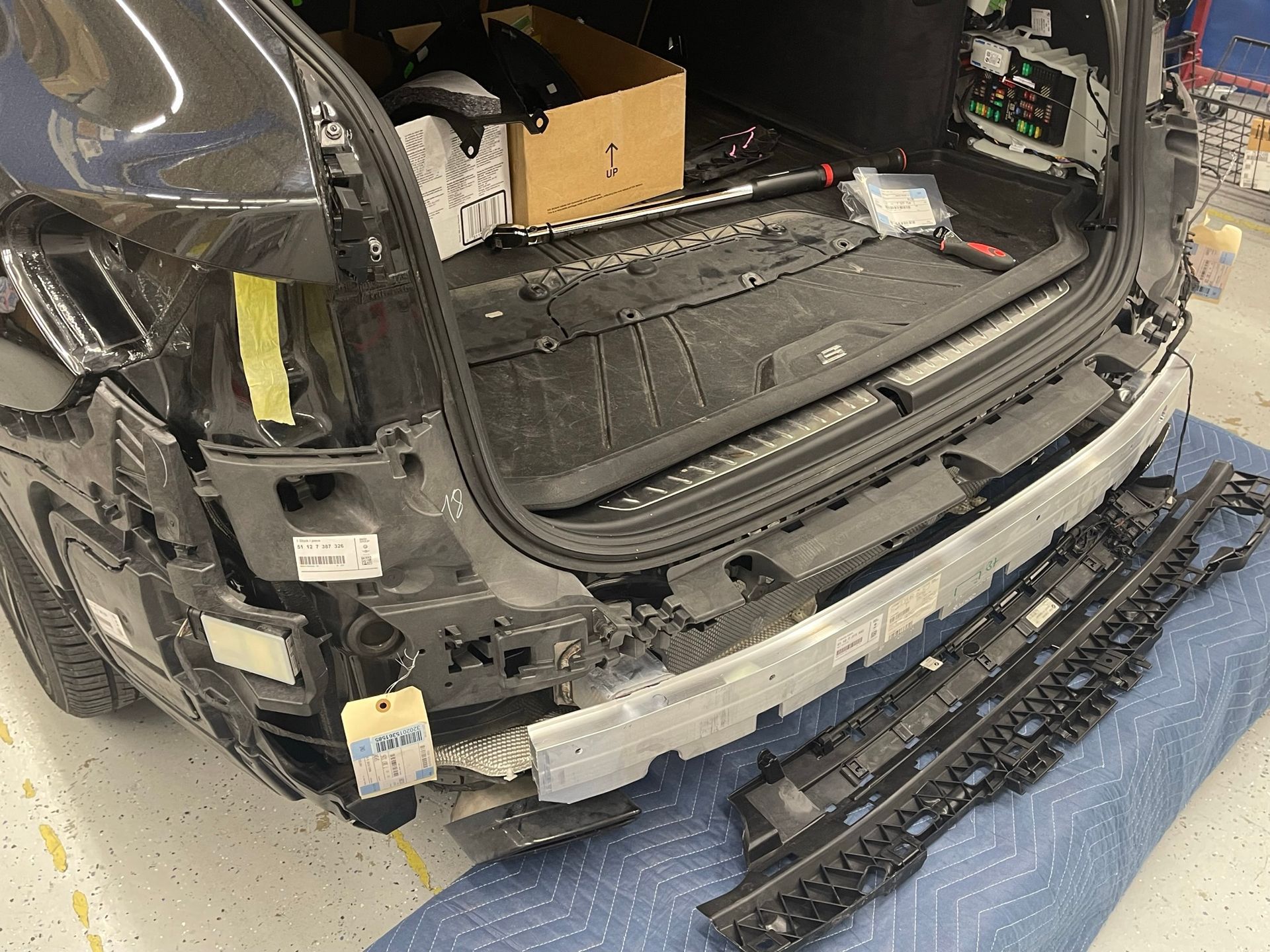 The rear bumper of a car is being removed.