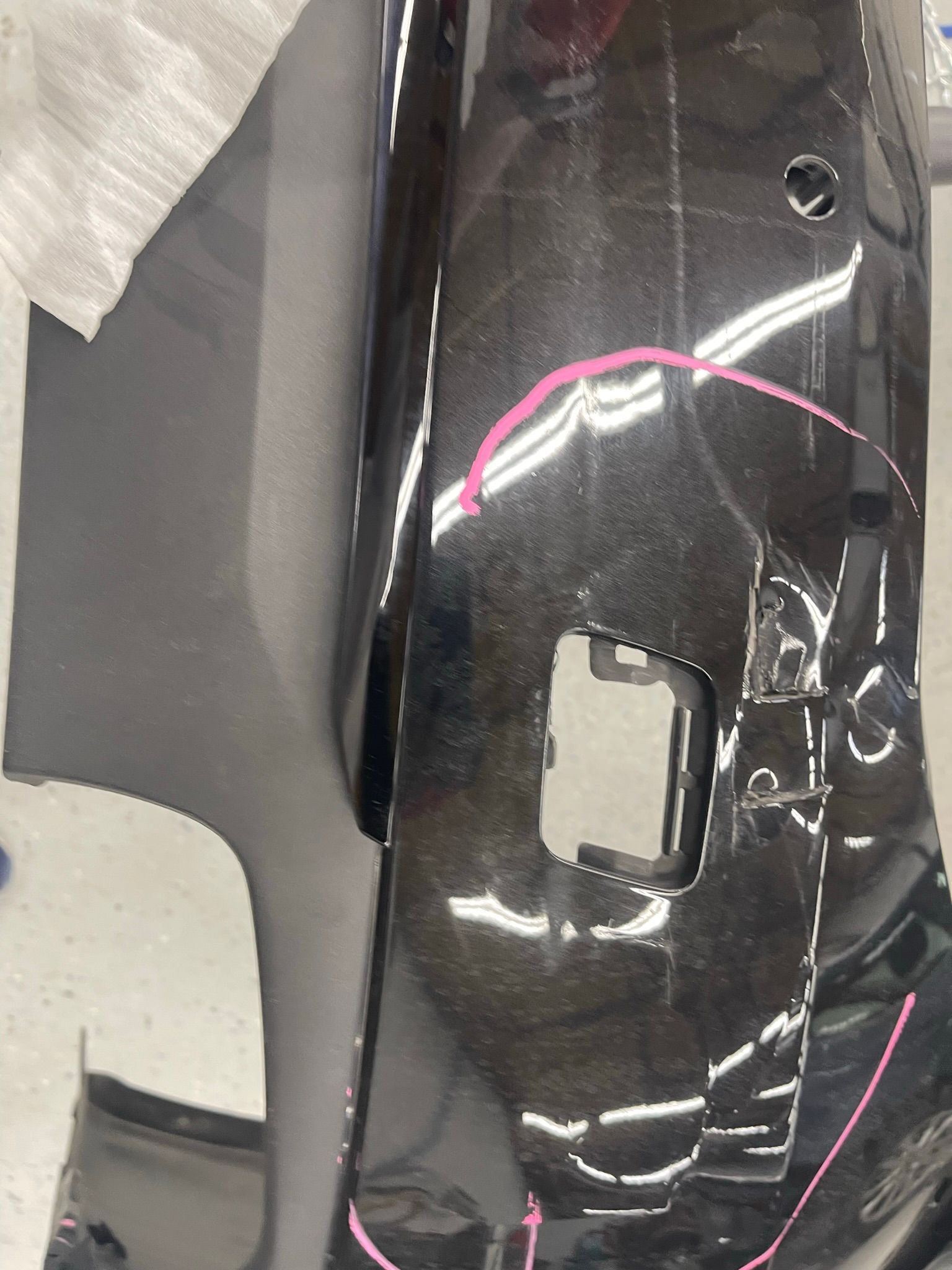 A black car bumper with a pink circle around it