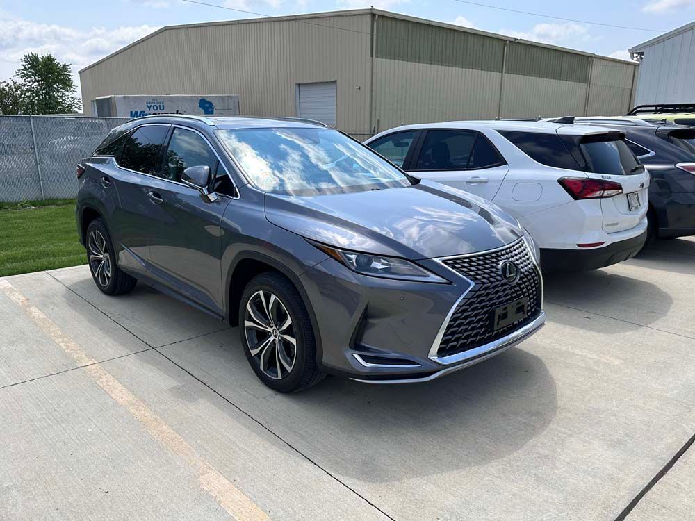 A gray lexus rx 350 is parked in a parking lot.
