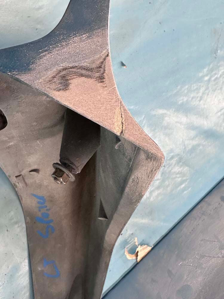 A close up of a piece of metal on a blue surface.