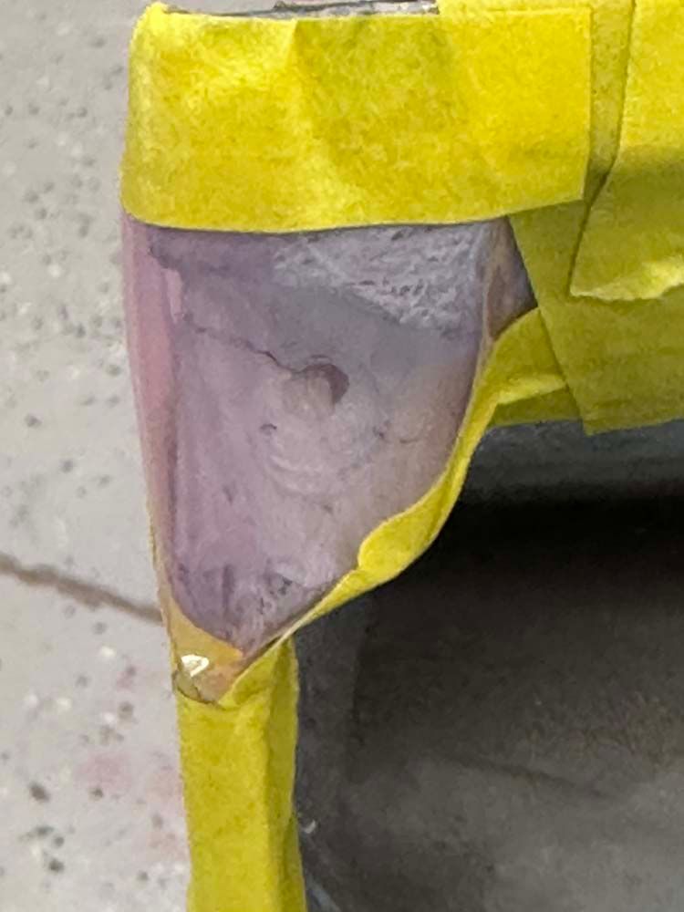 A close up of a car with yellow tape on it.