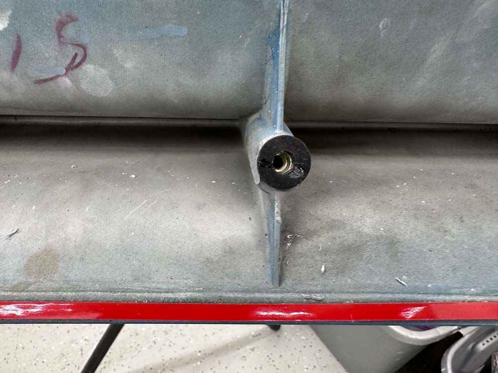 A piece of metal with the number 15 written on it