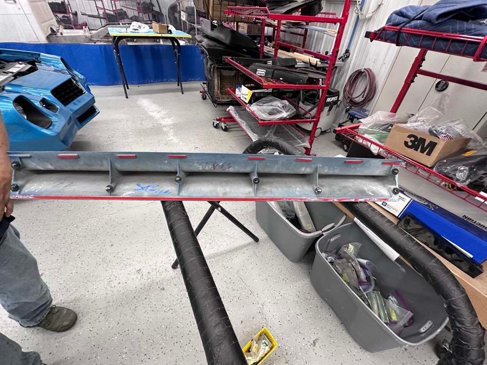 A man is standing in a garage next to a 3m box