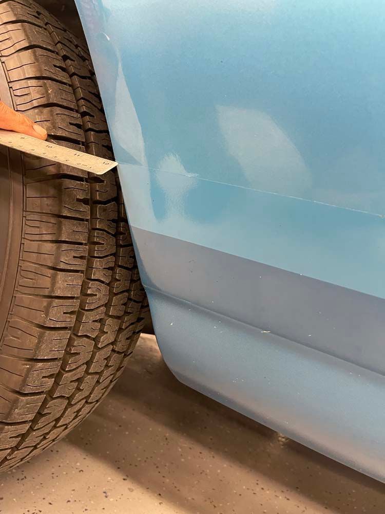 A close up of a tire on a blue car.
