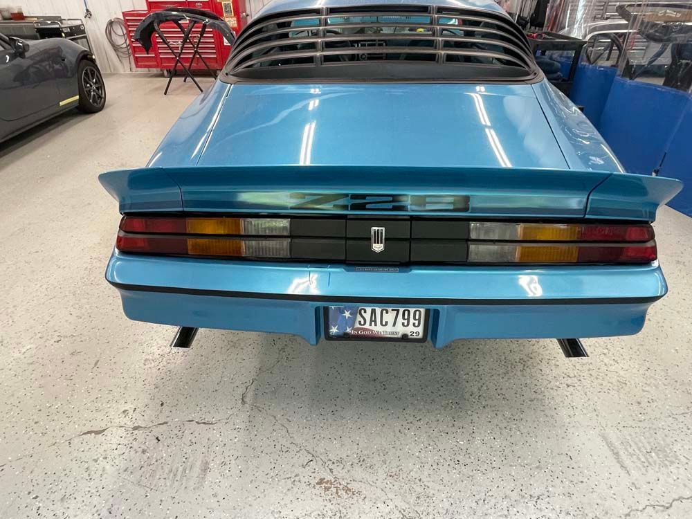 A blue car with a license plate that says slc799