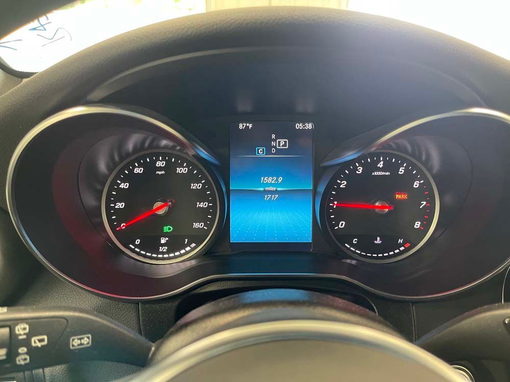 A close up of a car dashboard with a digital display.