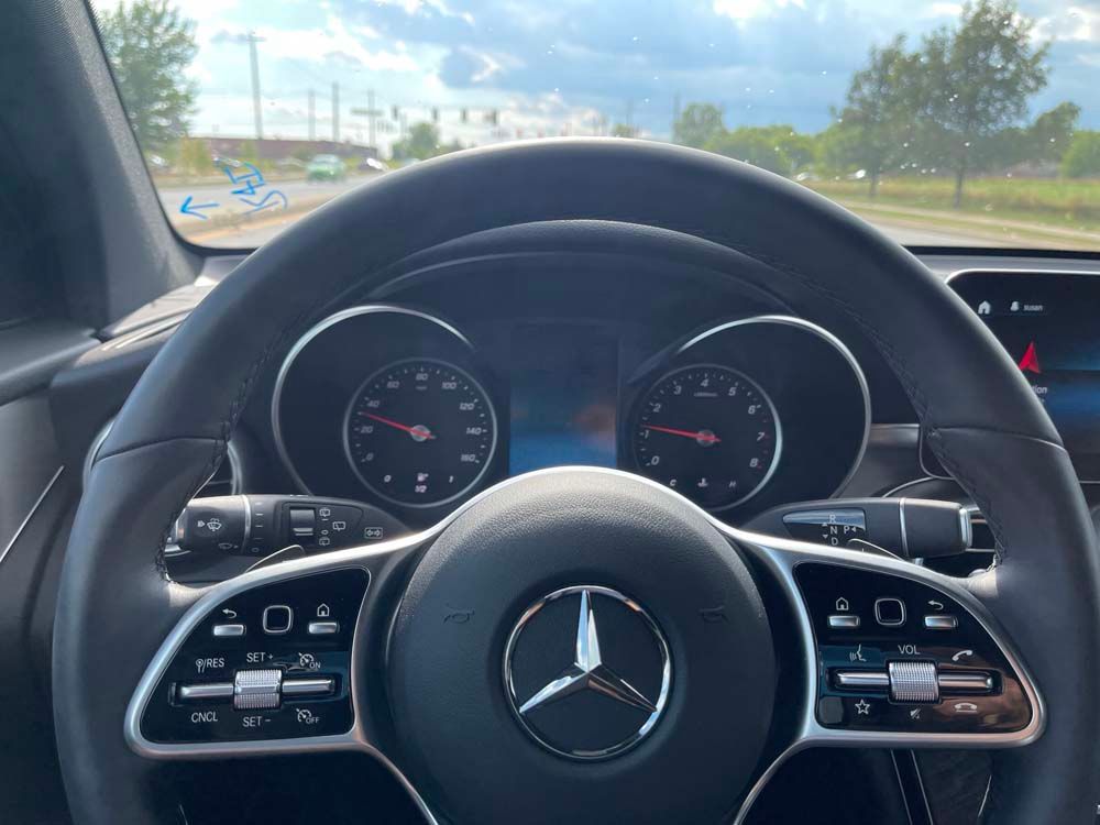 A close up of the steering wheel of a mercedes benz