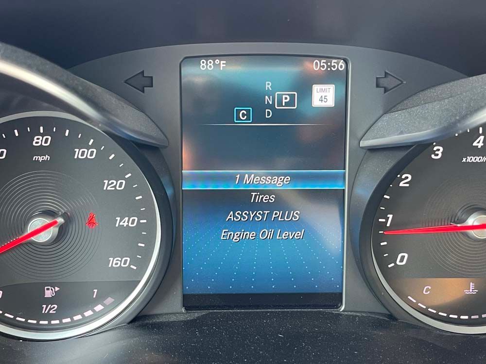 A close up of a car dashboard with a phone on it
