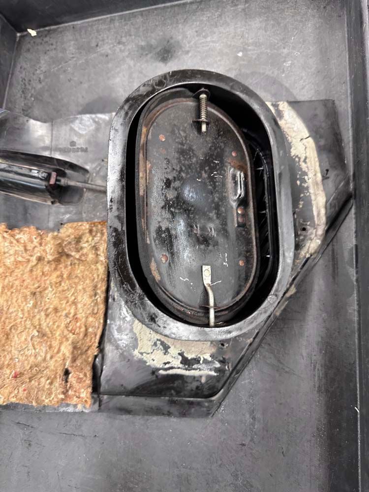 A close up of a metal object with a screwdriver in it.